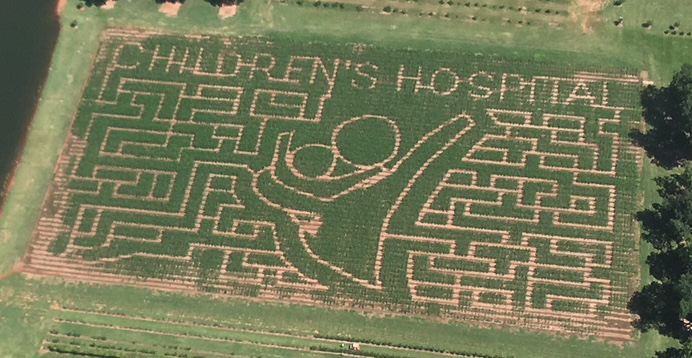 Aerial view of a field with the Children's Hospital logo cut into it